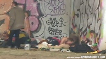 A Threesome Of Homeless Individuals Engaging In Sexual Activity In An Outdoor Setting