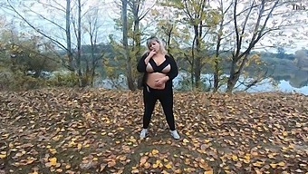 Middle-Aged Woman With Curves Enjoys Herself In A Public Park Near A Lake