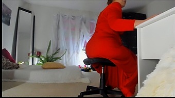 Sonya, The Mischievous Milf, Seductively Posing In A Long Red Dress